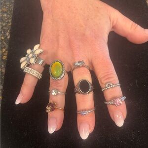 10 silvertone fashion rings. Sizes 5 1/2 to 7